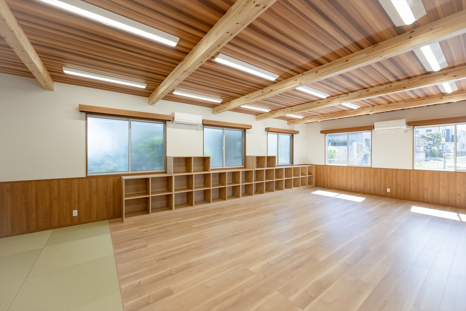 所沢市上新井小学校学童クラブの学習室。木質仕上げの内観と収納棚。