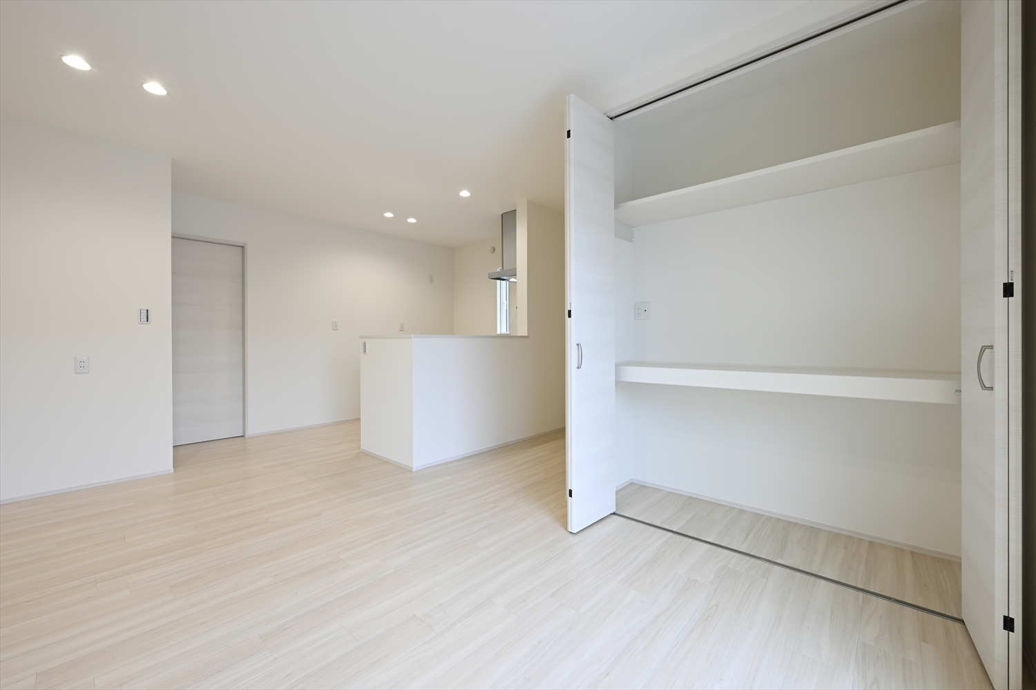 リビングに隣接した収納スペース、棚とカウンターがある多目的収納