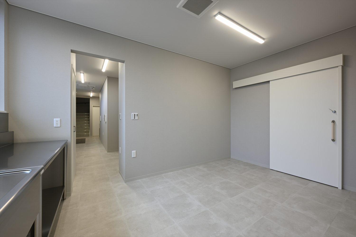 診察室の室内、作業カウンターと収納を備えた清潔感のある空間