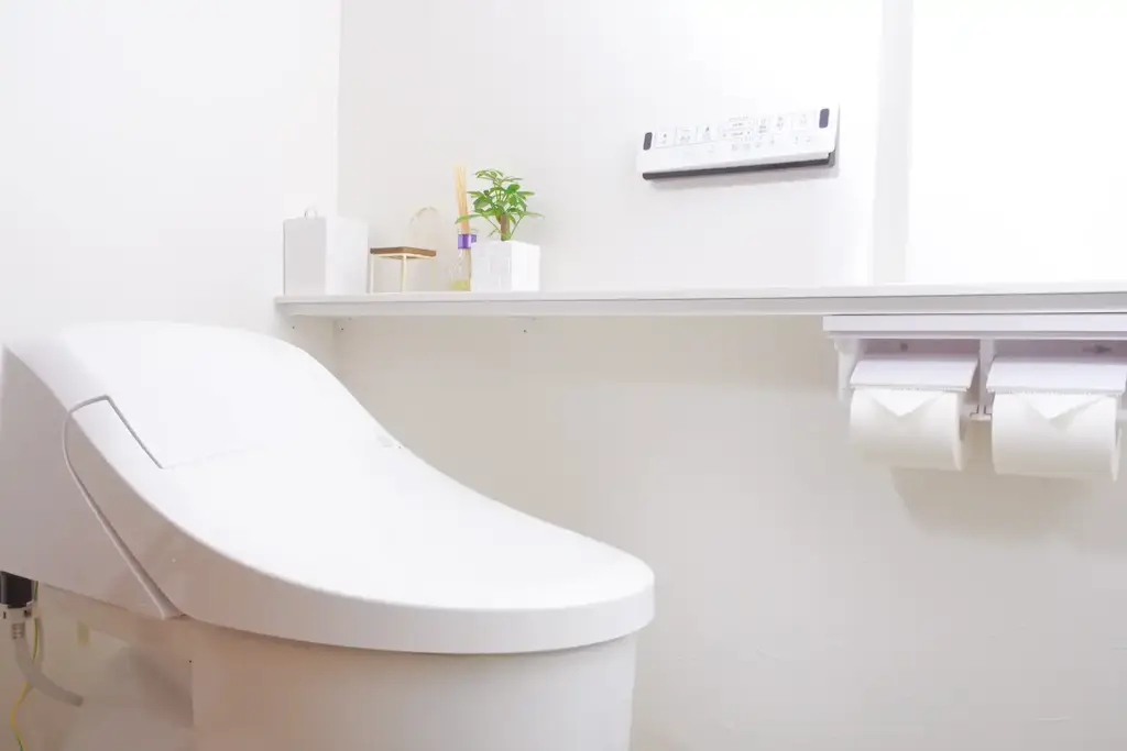 注文住宅の間取り図でトイレの位置を検討する家族